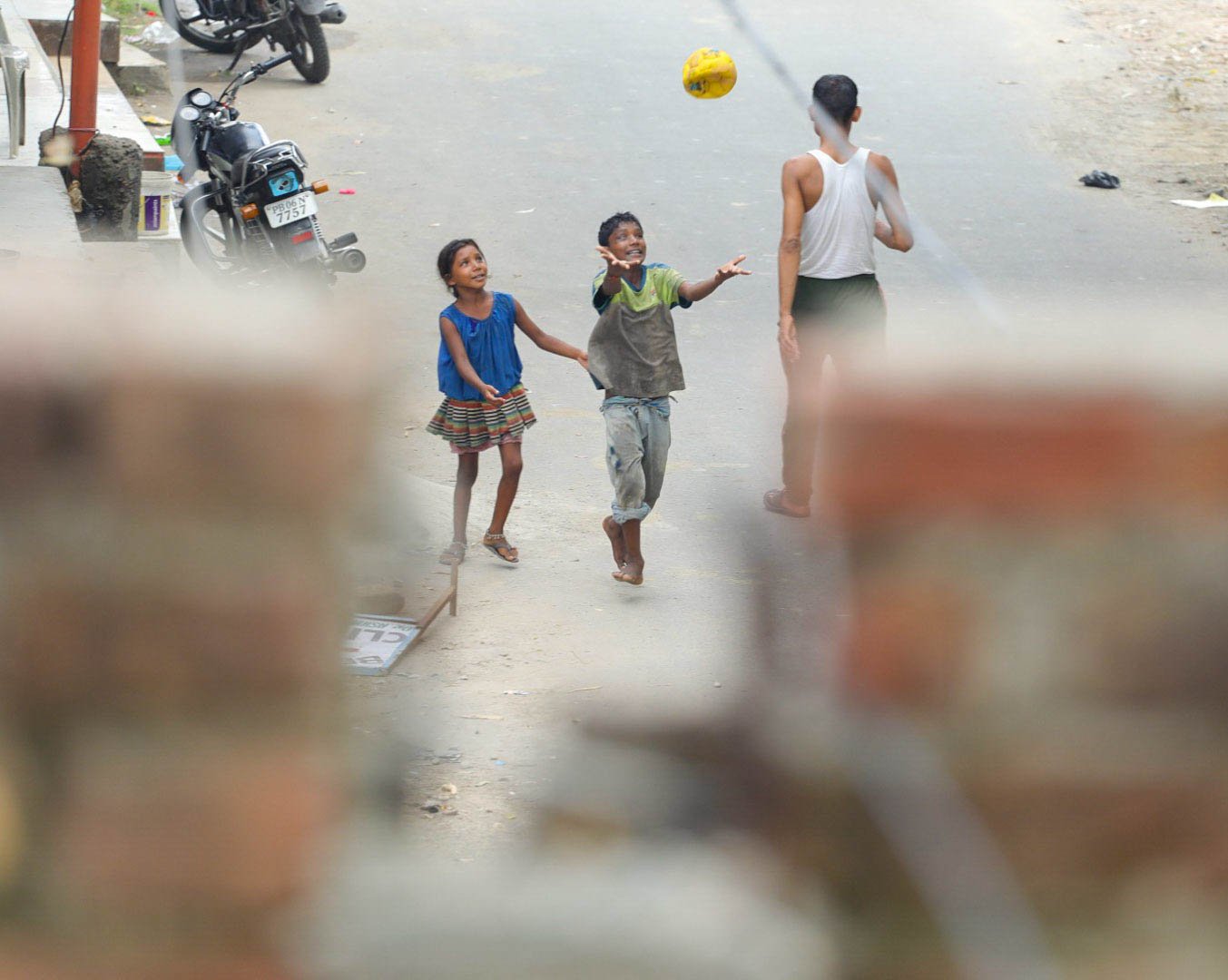 Children playing with a yellow ball