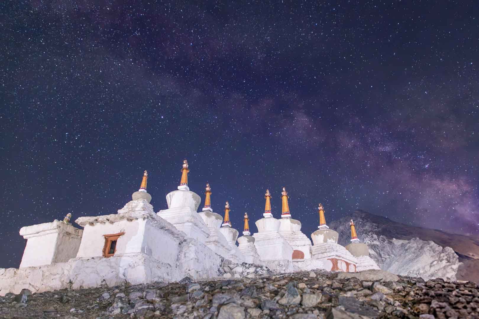 Stupas beneath a star-filled sky