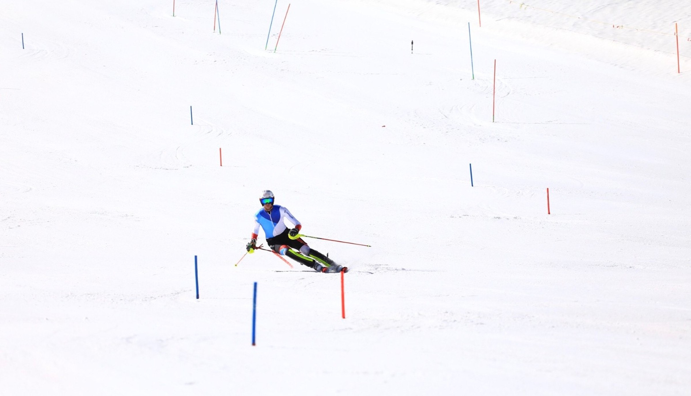 Alpine skier carving through a slalom course