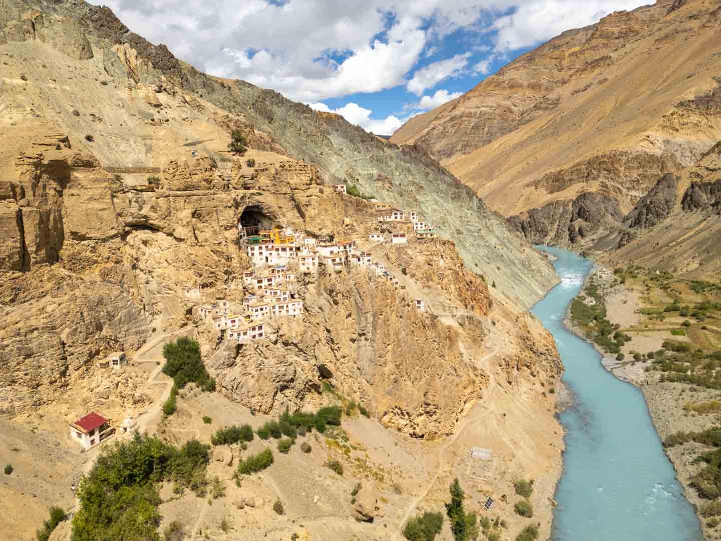 Cliffside settlement above a turquoise river valley