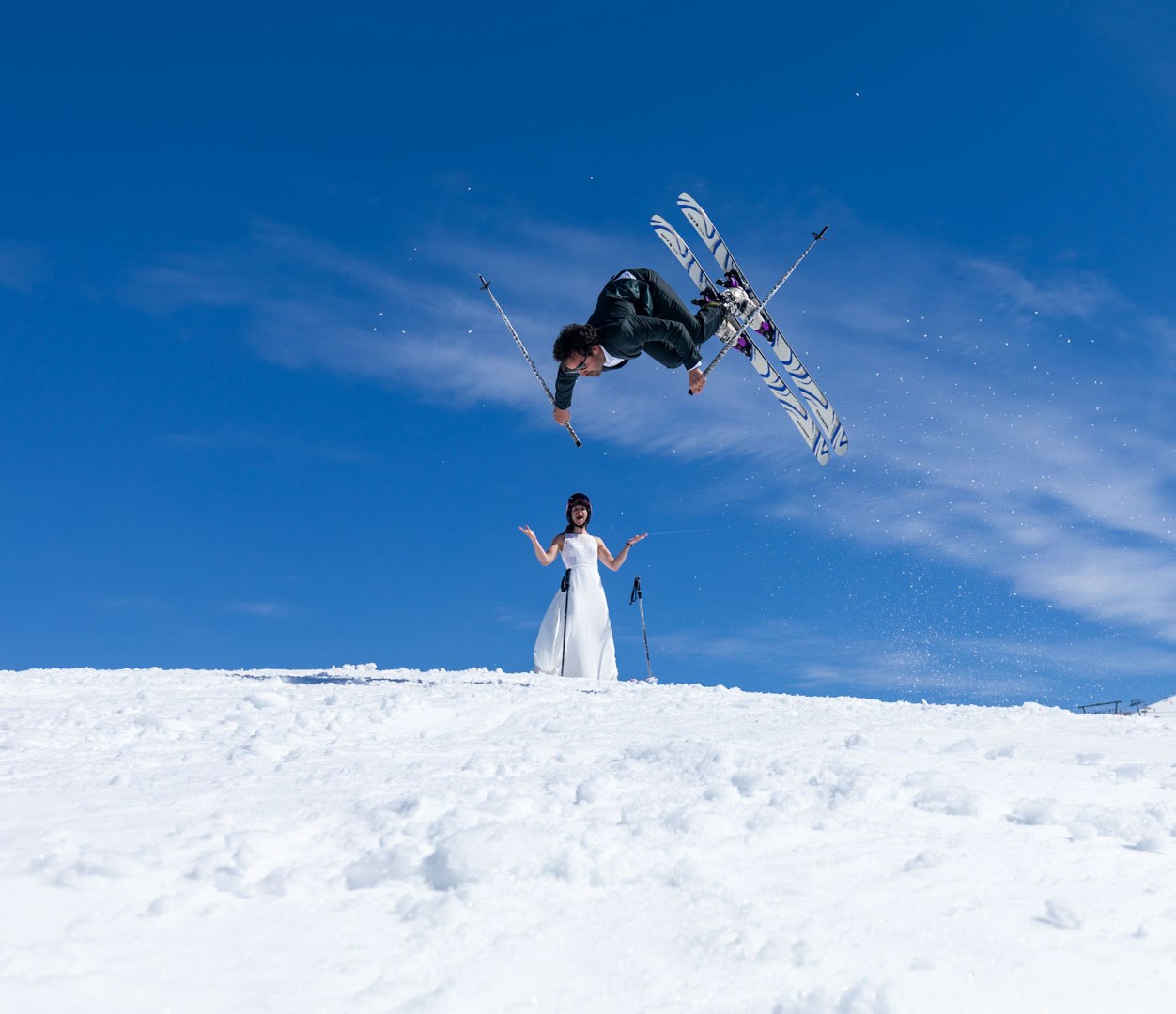 Freestyle skier flying above a snowy ridge