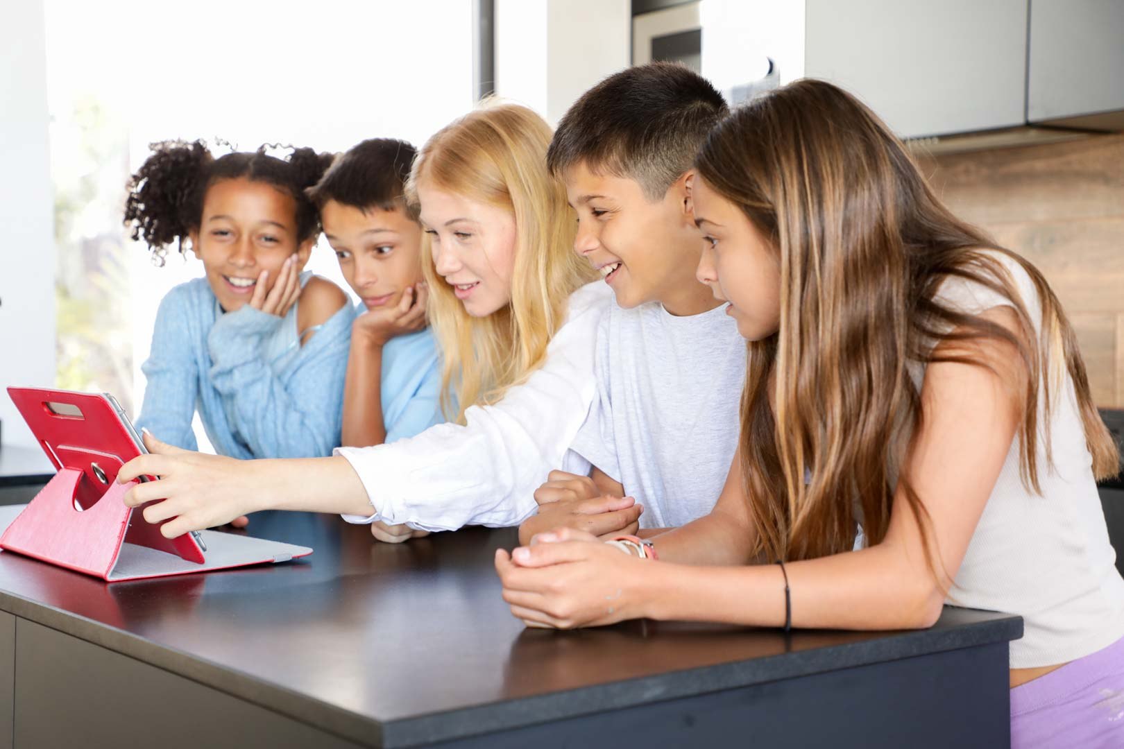 Children gathered around a tablet
